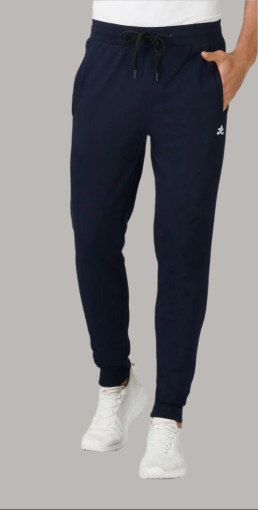 Navy blue jogger pants with drawstring waist and white sneakers, casual menswear