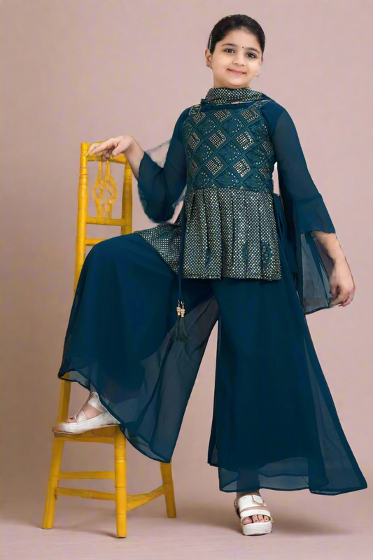 Girl in blue embroidered festive ethnic outfit and palazzo pants posing on yellow chair