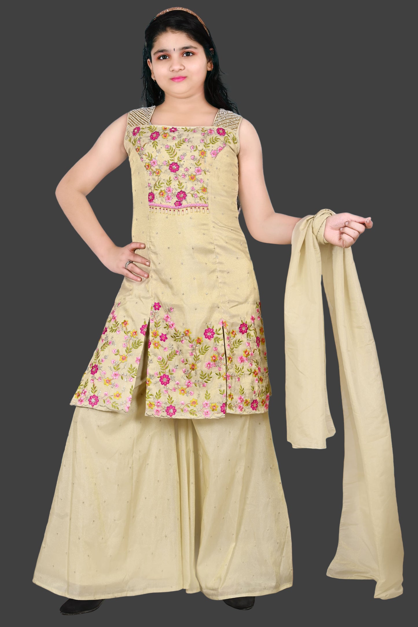 Woman wearing a floral embroidered outfit with a scarf, against a blue wall with a clock.