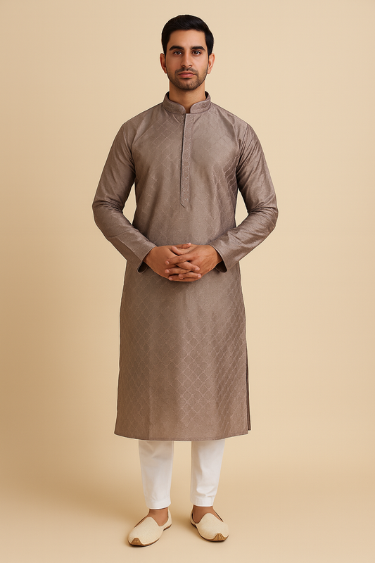 Man wearing a brown kurta with white pants on a beige background