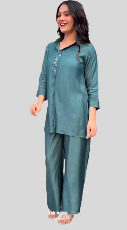 Woman wearing teal kurta set with sequin detailing, modern festive family fashion