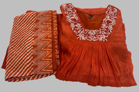 Rust orange kurta with white floral embroidery and matching geometric dupatta