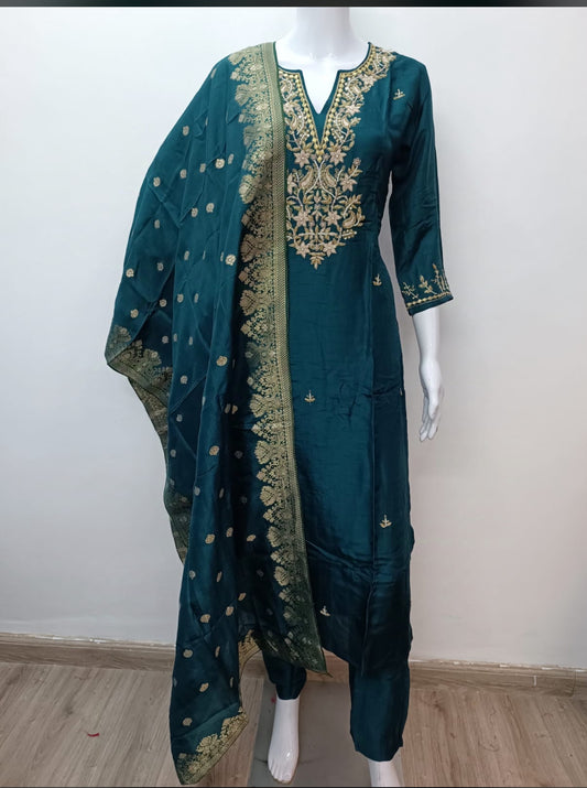 Teal blue embroidered salwar suit set with gold threadwork and matching dupatta on mannequin