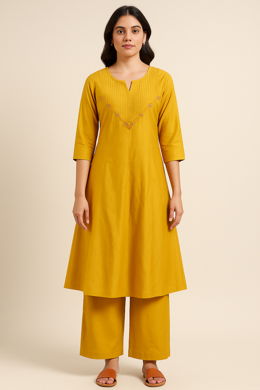 Woman wearing a yellow kurta with palazzo pants on a beige background