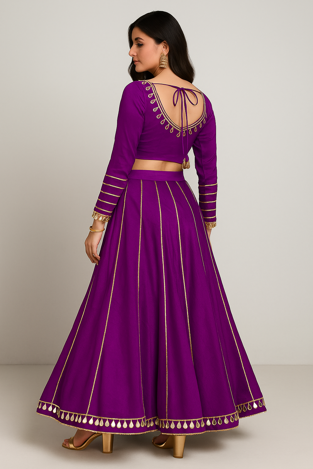 Purple traditional outfit with intricate designs on a plain background