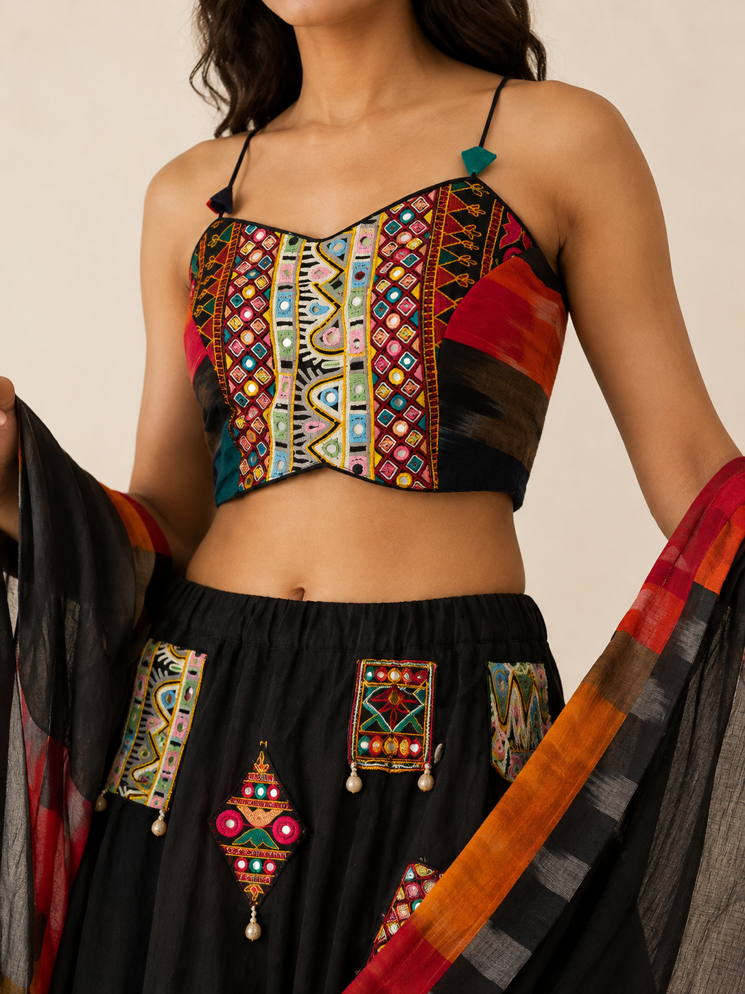 Close-up of multicolour embroidery mirror accents and woven border