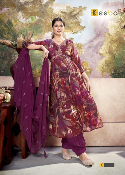 Woman modeling a floral maroon and gold festive salwar suit with dupatta, elegant background
