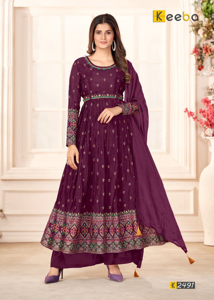 Woman wearing purple embroidered Anarkali suit with dupatta, traditional festive outfit