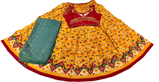 Yellow printed lehenga choli set with embroidered red blouse and green dupatta, festive wear