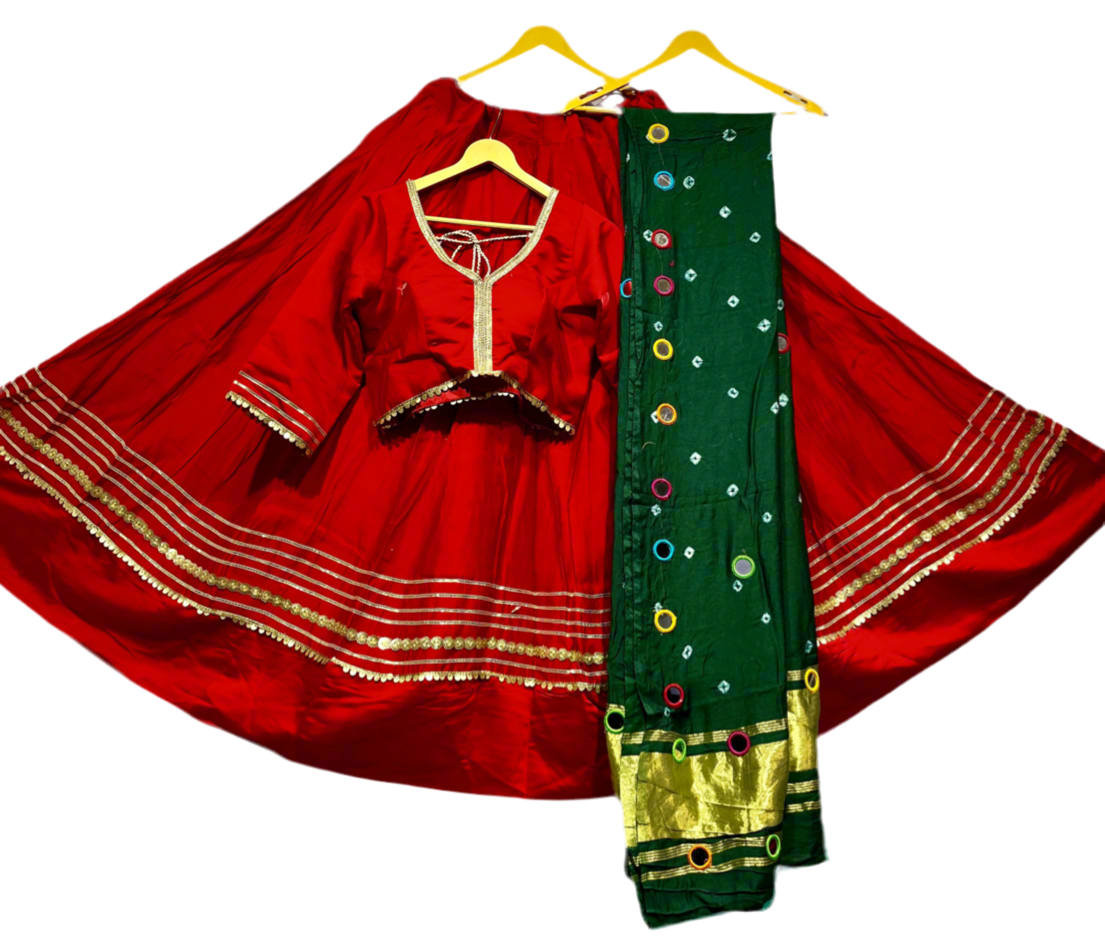 Red festive lehenga choli set with gold trim and green embroidered dupatta on hangers