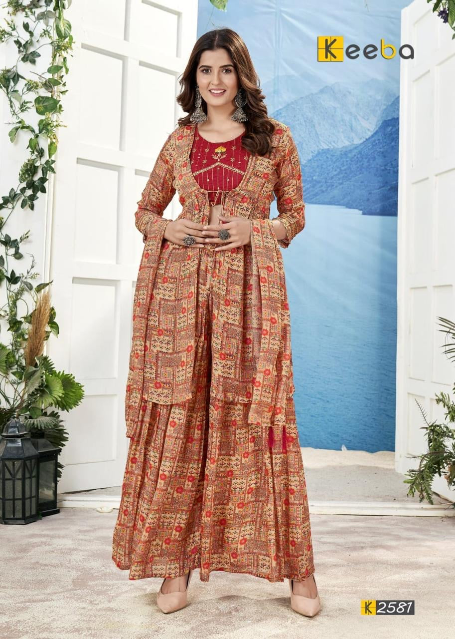 Woman in printed festive ethnic palazzo suit with dupatta, silver earrings, indoor setting