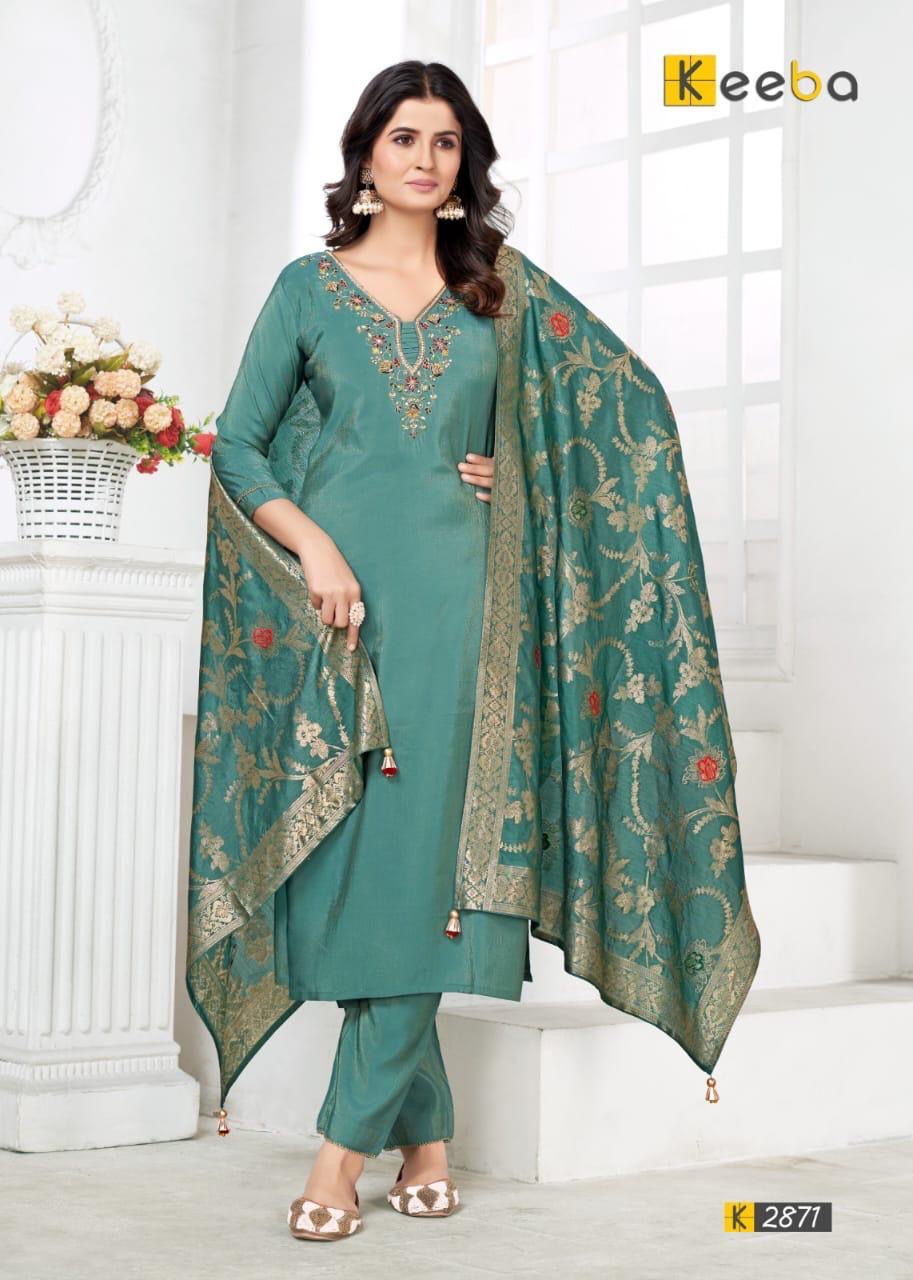 Woman wearing teal green embroidered salwar kameez with floral dupatta, festive ethnic fashion