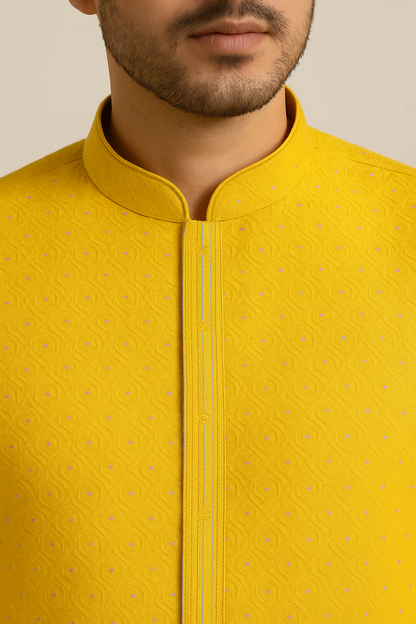 Yellow embroidered shirt worn by a person on a beige background