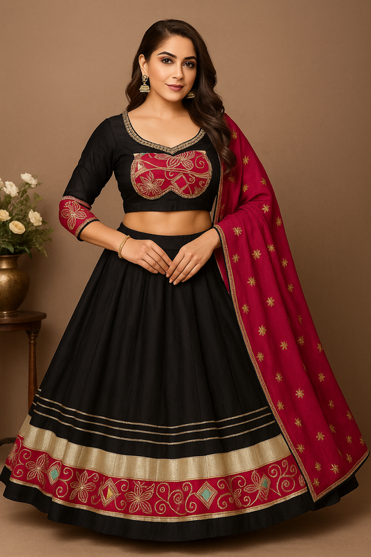 Woman wearing a black and red traditional outfit with a pink dupatta on a brown background