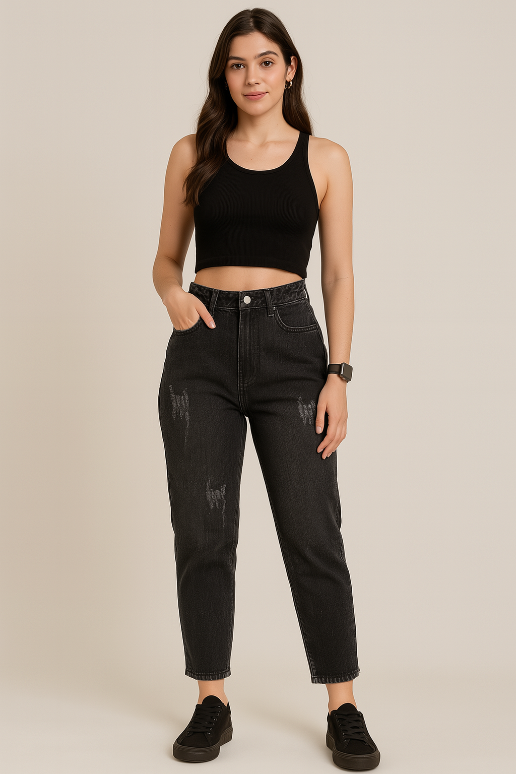 Woman wearing a black tank top and black jeans on a beige background