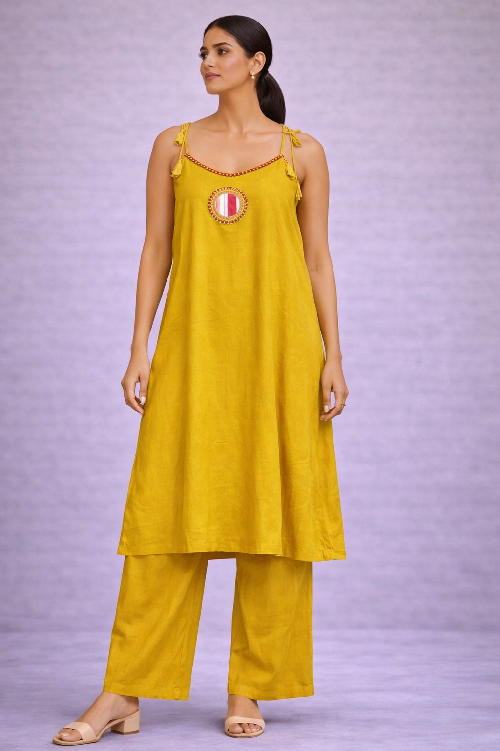 Woman wearing a yellow outfit with a purple background