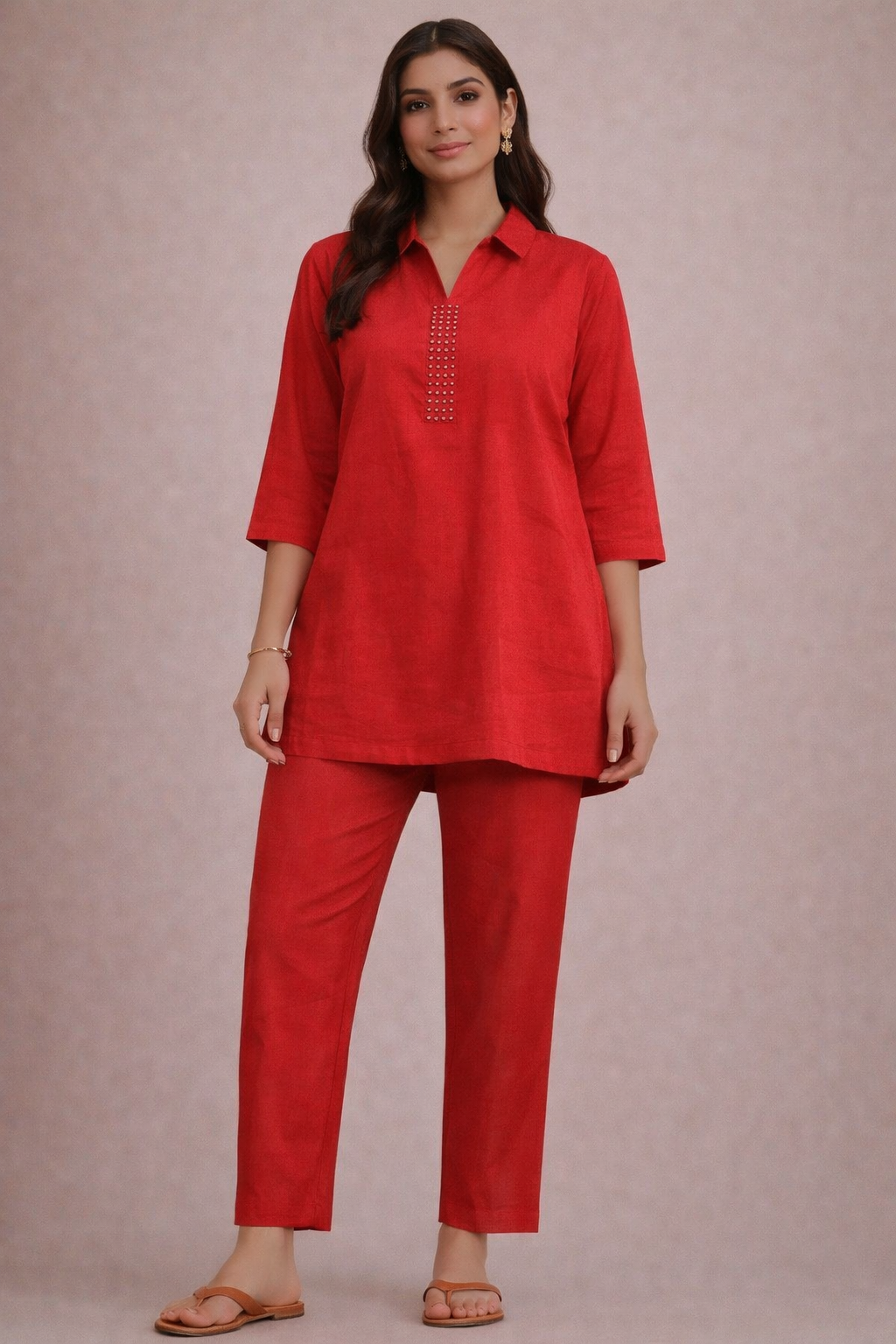 Woman wearing a red outfit with a plain background