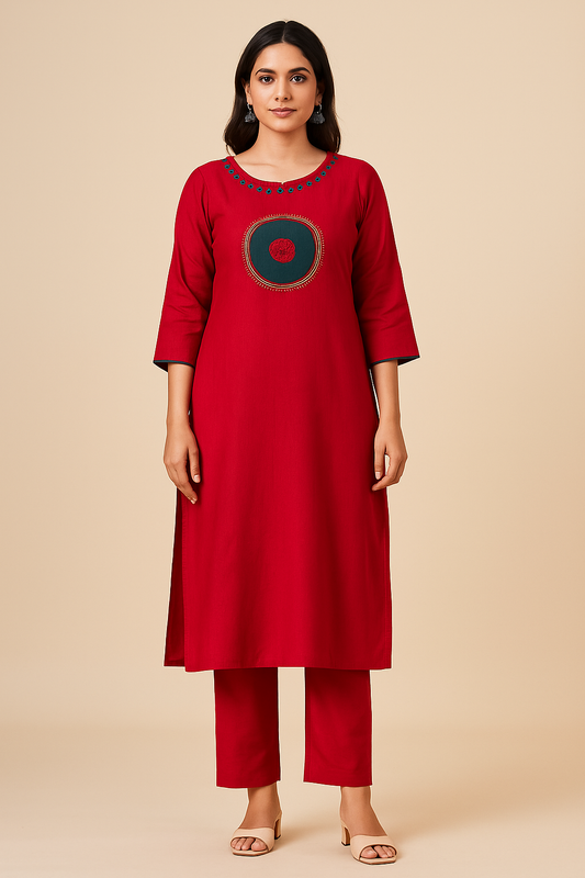 Woman wearing a red kurta with a circular design on a beige background