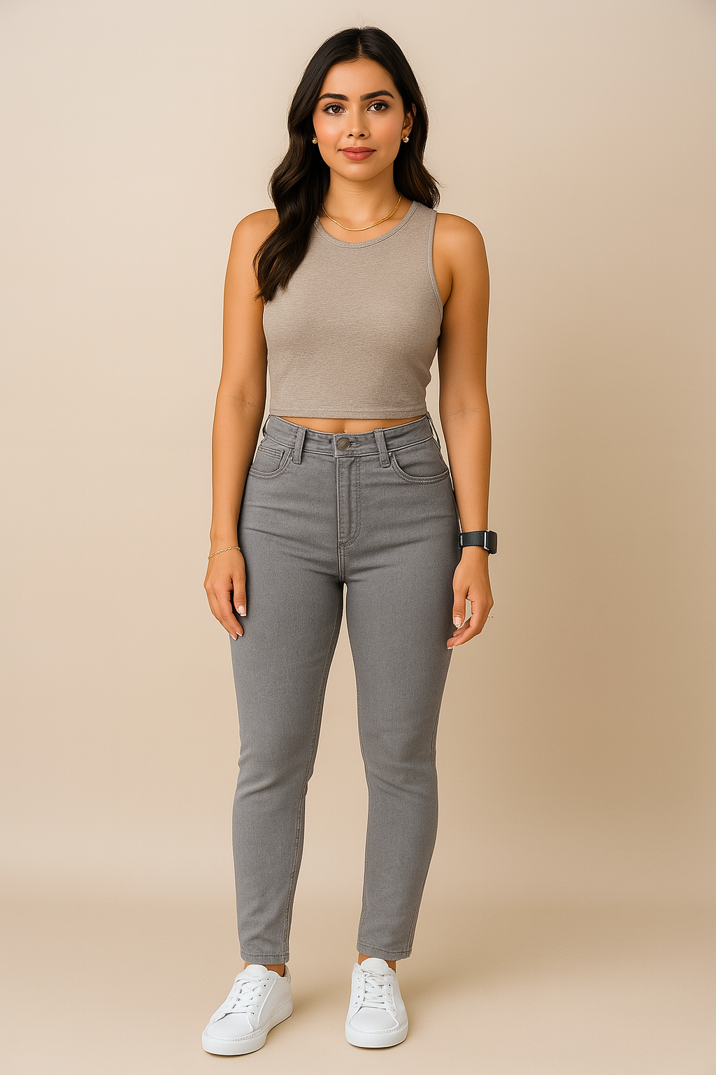 Woman wearing a beige tank top and gray pants on a beige background