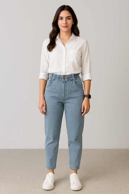 Woman wearing a white shirt and light blue jeans against a plain background