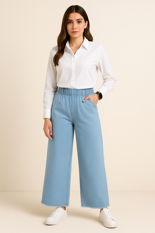 Woman wearing a white shirt and light blue pants on a beige background