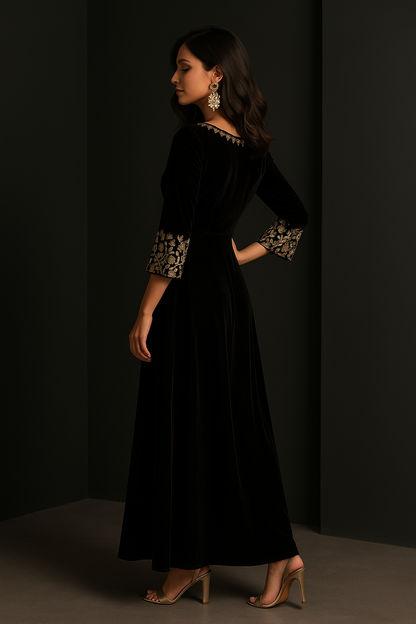 Woman wearing a black dress with floral embellishments against a dark background