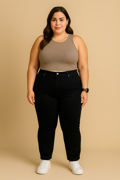 Woman wearing a beige tank top and black pants on a beige background
