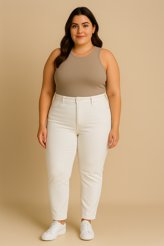 Woman wearing a beige tank top and white pants against a beige background