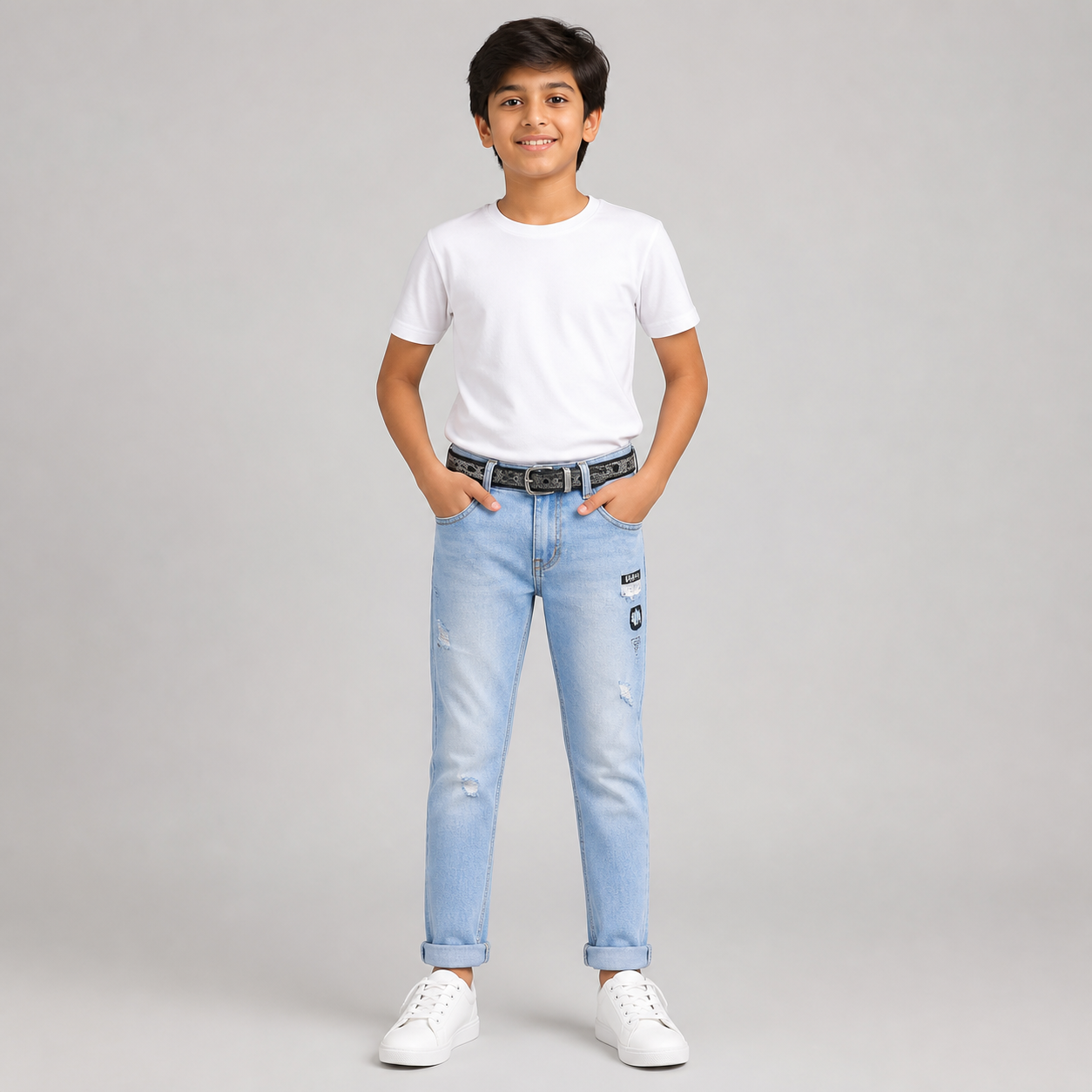Boy model wearing sky blue printed denim jeans with a black belt