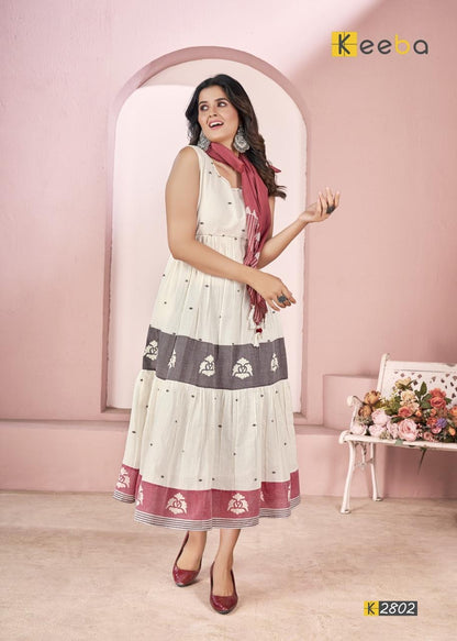 Woman wearing sleeveless ethnic maxi dress with maroon scarf, floral print borders, indoor setting