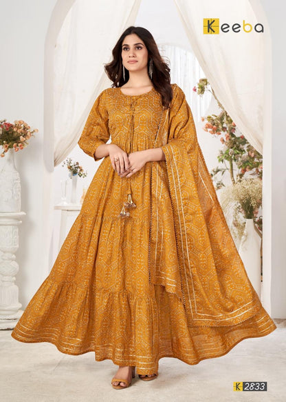 Woman in mustard yellow printed ethnic dress with dupatta, festive Indian fashion