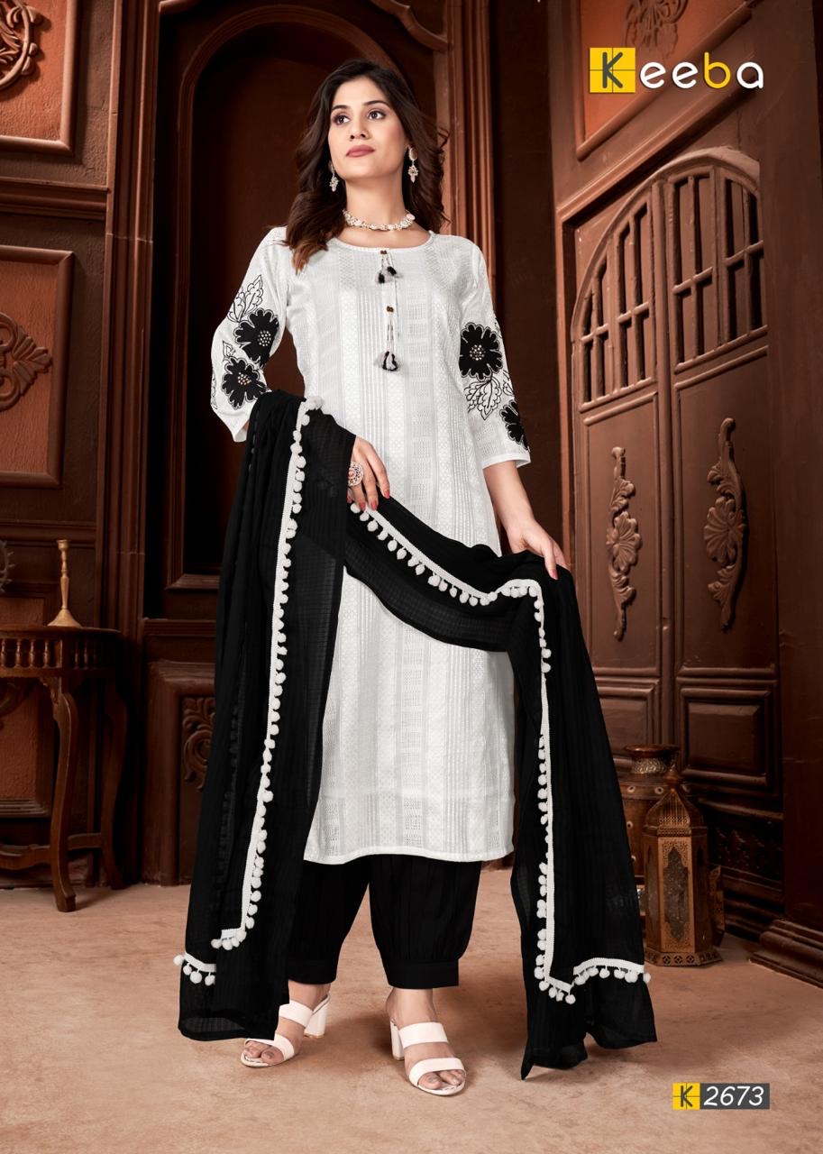 Woman in black and white ethnic suit with floral embroidery and matching dupatta, festive fashion
