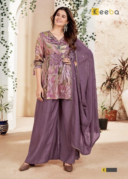 Woman wearing a purple printed kurta set with palazzo pants and dupatta, festive ethnic fashion.