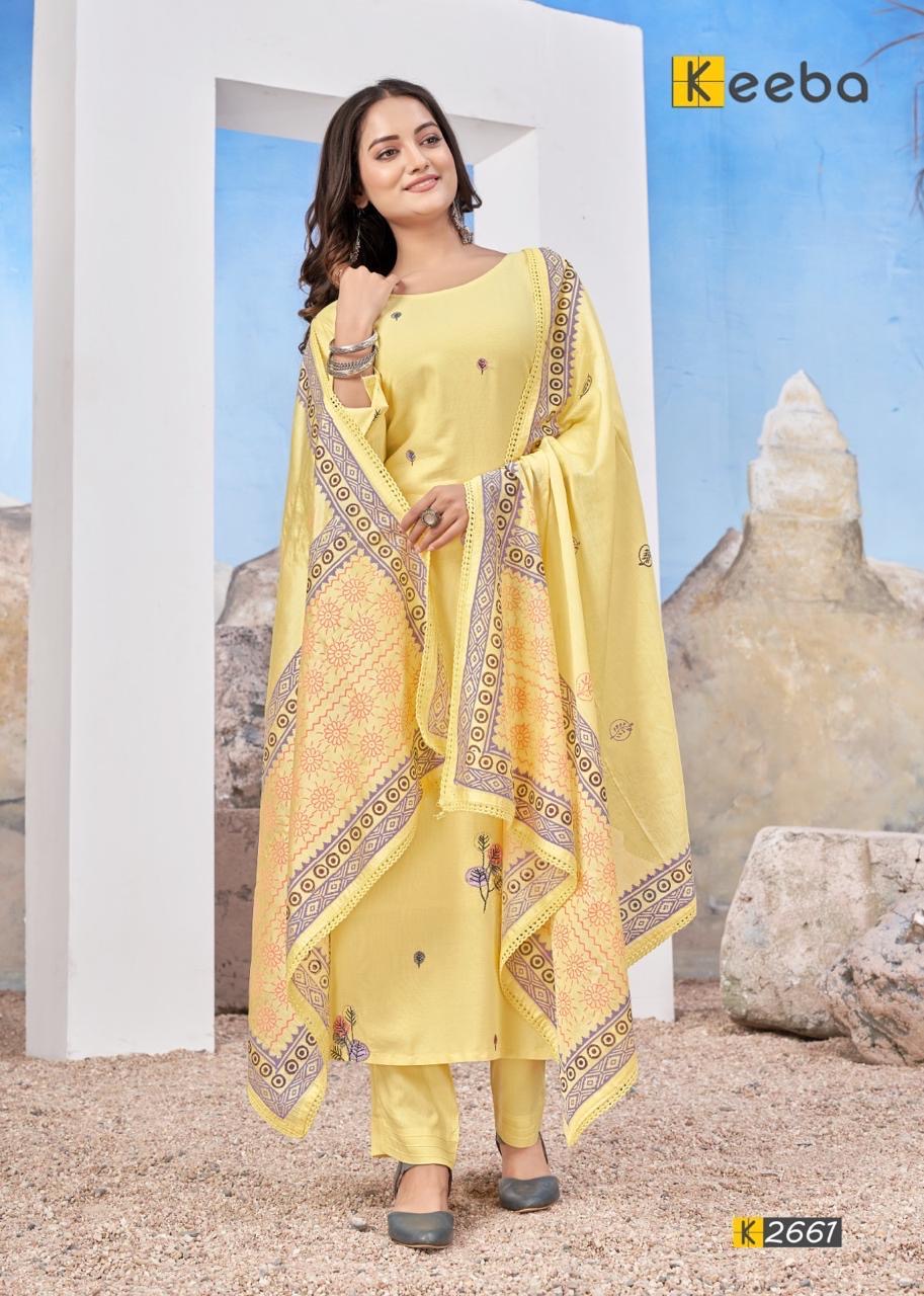 Woman wearing yellow printed salwar kameez with dupatta, standing outdoors