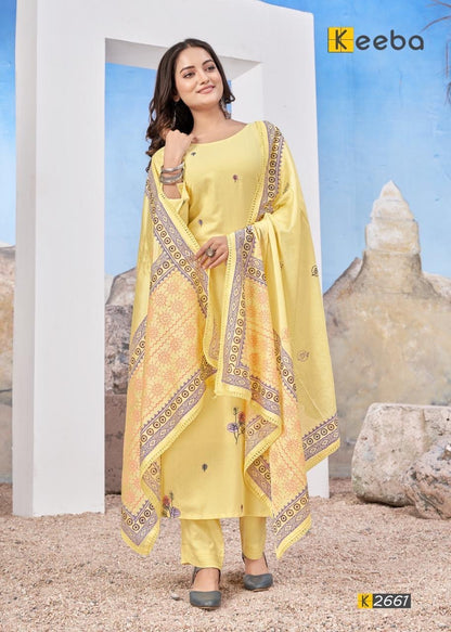 Woman wearing yellow printed salwar kameez with dupatta, standing outdoors